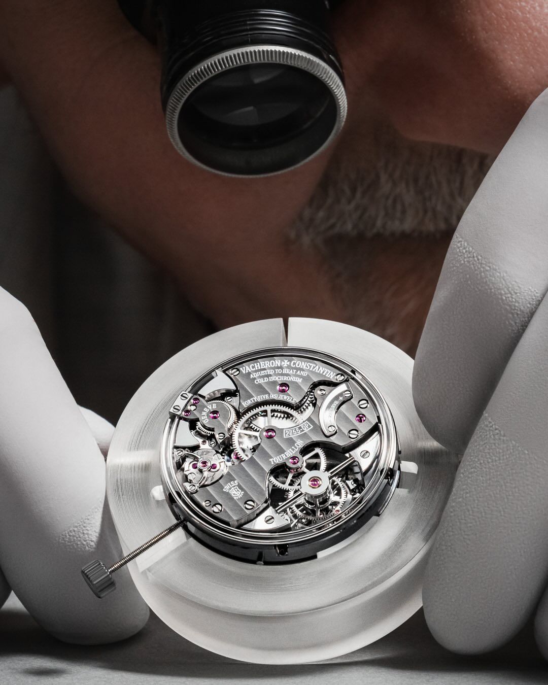 Watchmaker servicing a mechanical movement at Dauri Club, Tbilisi